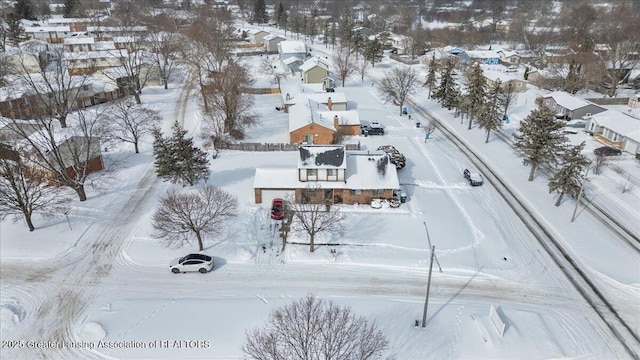 snowy aerial view featuring a residential view