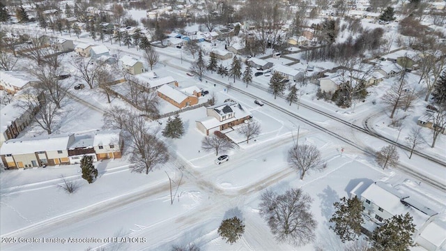 snowy aerial view featuring a residential view