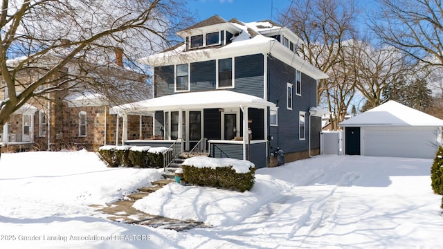 traditional style home with an outbuilding, a porch, and a detached garage