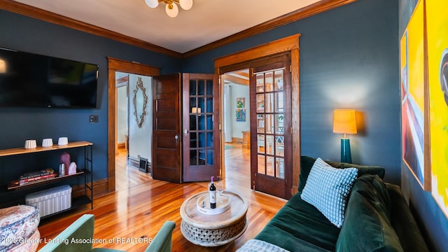 interior space featuring french doors, crown molding, and wood finished floors