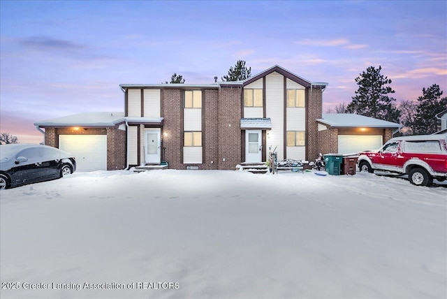 view of front facade featuring a garage and brick siding