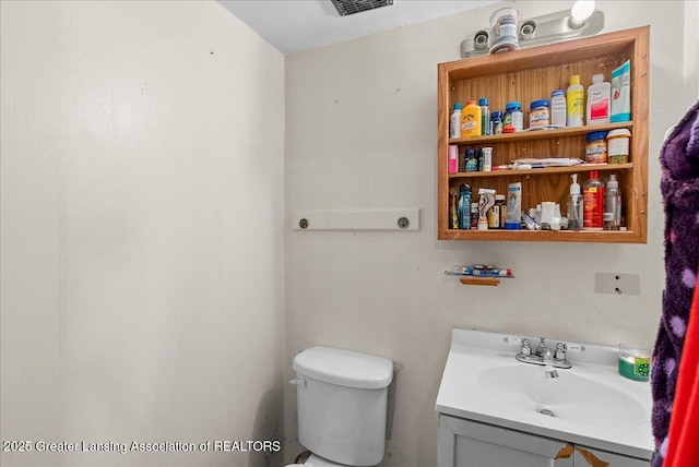 bathroom featuring toilet and vanity