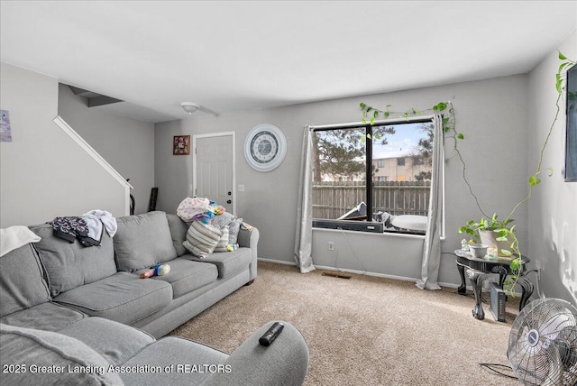 carpeted living room with visible vents and baseboards