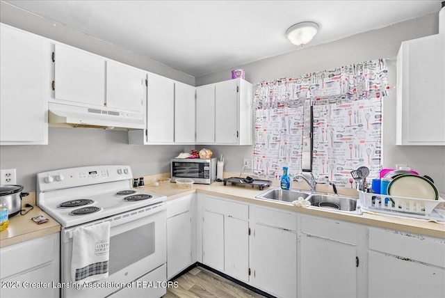 kitchen with under cabinet range hood, a sink, white cabinets, light countertops, and white electric range oven