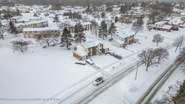 snowy aerial view featuring a residential view