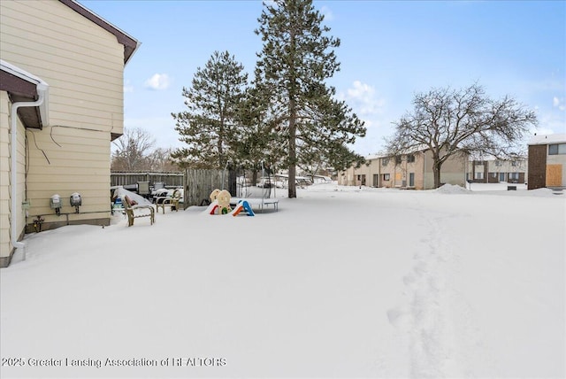 snowy yard with fence