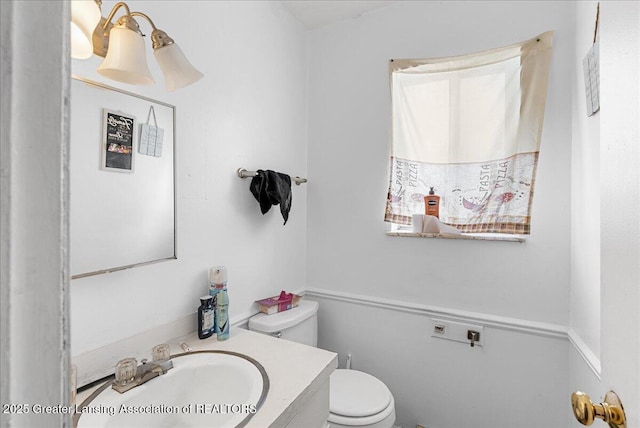 bathroom featuring vanity and toilet