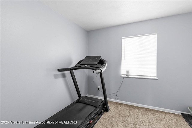 workout area with light carpet and baseboards