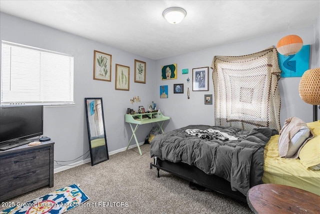 bedroom featuring light carpet and baseboards