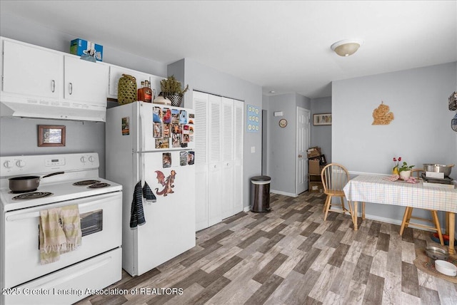 kitchen featuring light countertops, light wood-style flooring, white cabinetry, white appliances, and under cabinet range hood