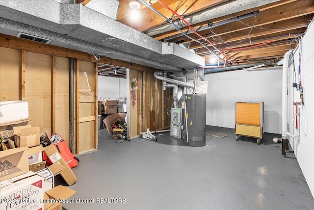 unfinished basement featuring gas water heater and visible vents