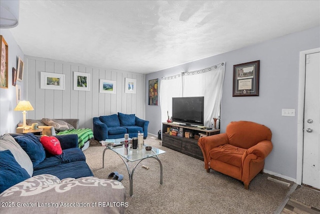 living room featuring baseboards and a textured ceiling