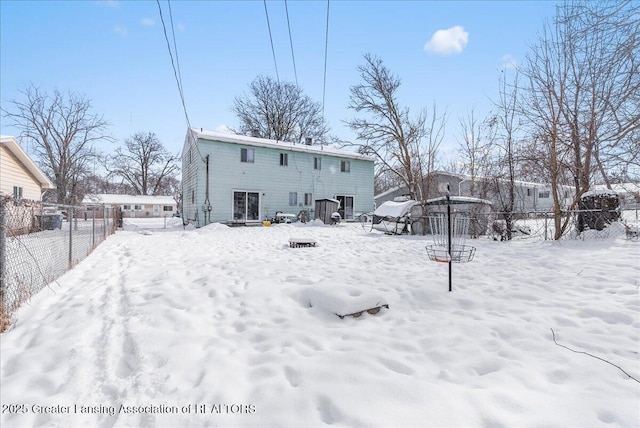 snow covered property featuring fence