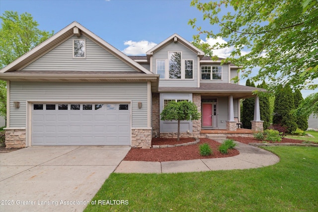 11610 Hibiscus Ln, Grand Ledge, MI 48837 - view of front of house featuring stone siding, driveway, a porch, a garage, and a front yard