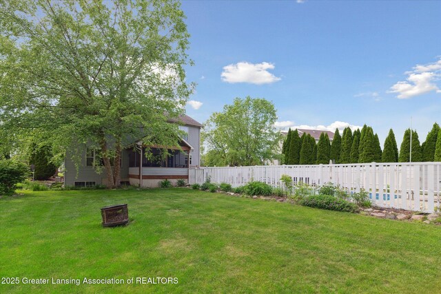 11610 Hibiscus Ln, Grand Ledge, MI 48837 - view of yard featuring an outdoor fire pit