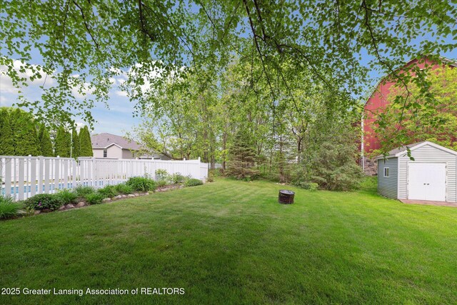 11610 Hibiscus Ln, Grand Ledge, MI 48837 - view of yard featuring an outdoor fire pit and a detached garage