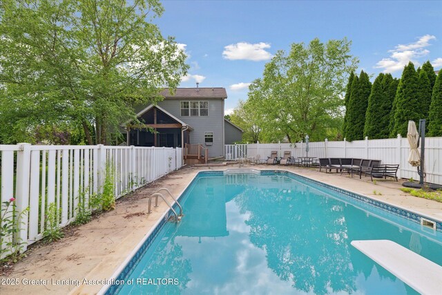 11610 Hibiscus Ln, Grand Ledge, MI 48837 - view of pool with a sunroom, a fenced backyard, a diving board, and a patio