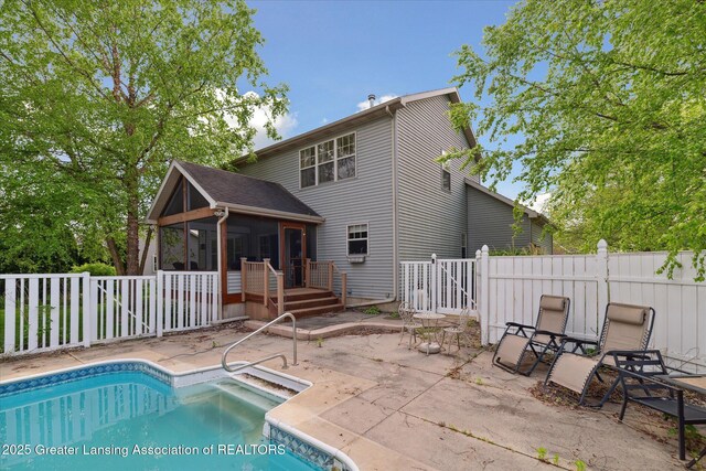 11610 Hibiscus Ln, Grand Ledge, MI 48837 - rear view of property featuring a sunroom, a patio, and a deck