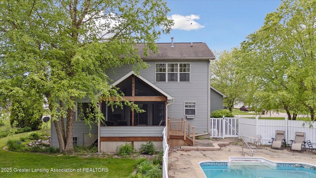 11610 Hibiscus Ln, Grand Ledge, MI 48837 - rear view of property with a sunroom, a patio area, and roof with shingles