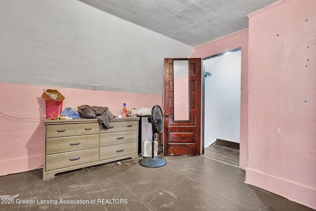 bedroom with vaulted ceiling and baseboards