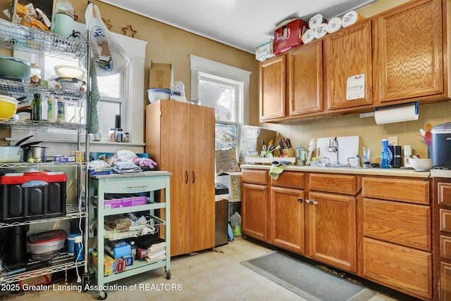 kitchen featuring brown cabinets, light countertops, and light floors