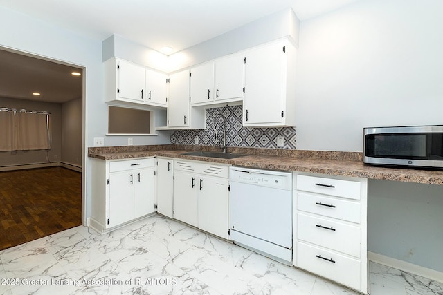 kitchen featuring dishwasher, stainless steel microwave, marble finish floor, white cabinetry, and a sink