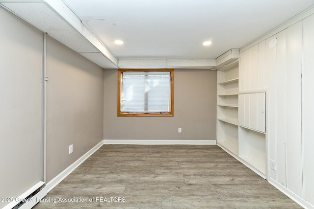 unfurnished room featuring light wood-style floors, recessed lighting, and baseboards