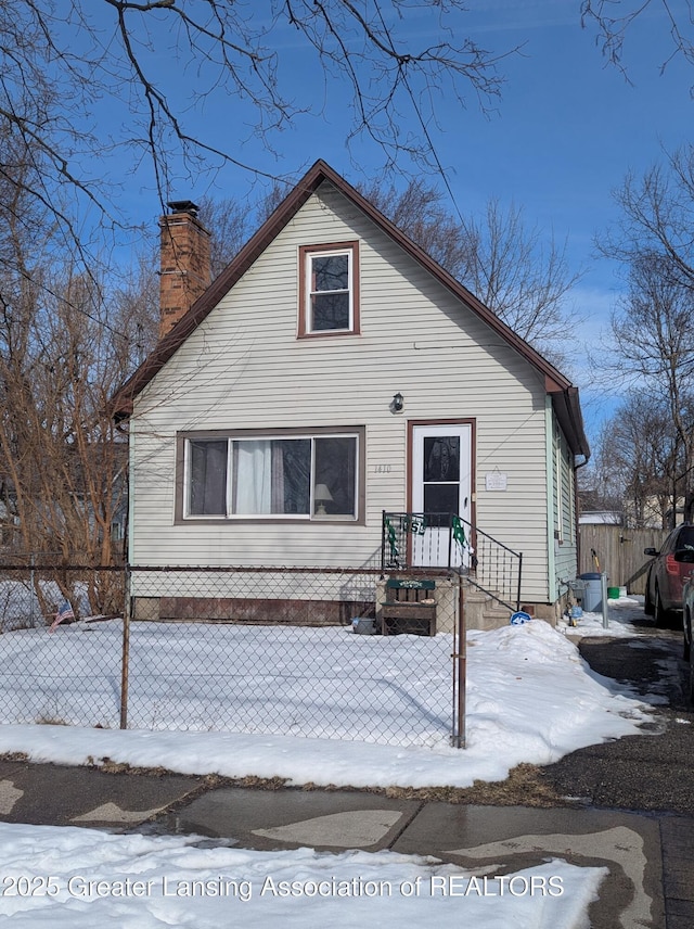 bungalow-style house featuring a chimney