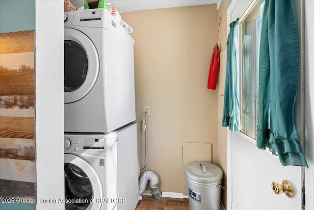 laundry area featuring laundry area and stacked washer / drying machine