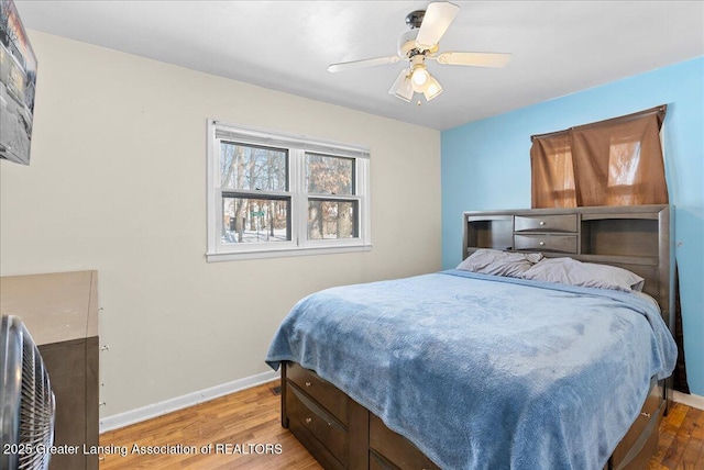 bedroom featuring ceiling fan, wood finished floors, and baseboards