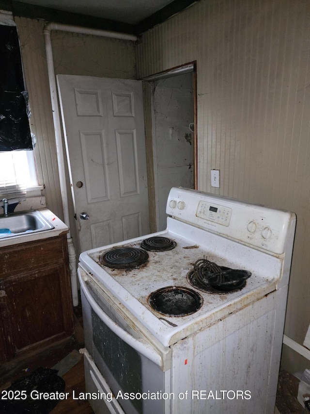 kitchen with double oven range, light countertops, and a sink