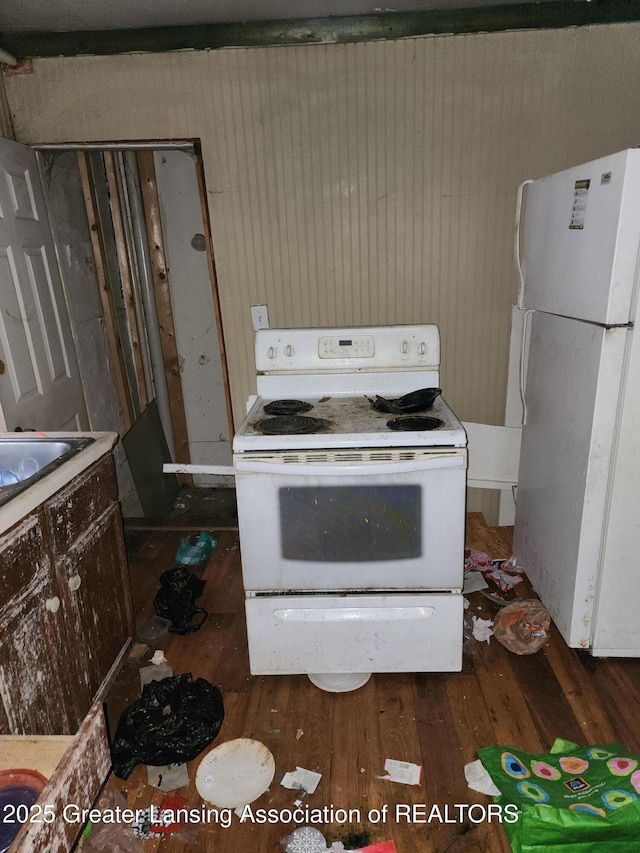 kitchen featuring white appliances and dark wood finished floors