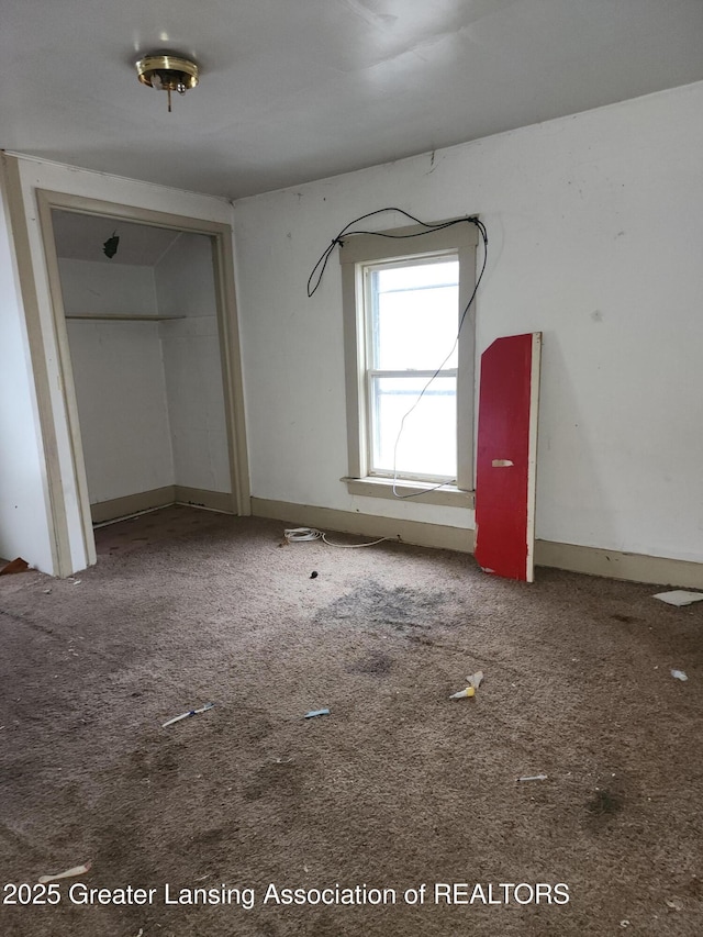 unfurnished bedroom with carpet floors and a closet