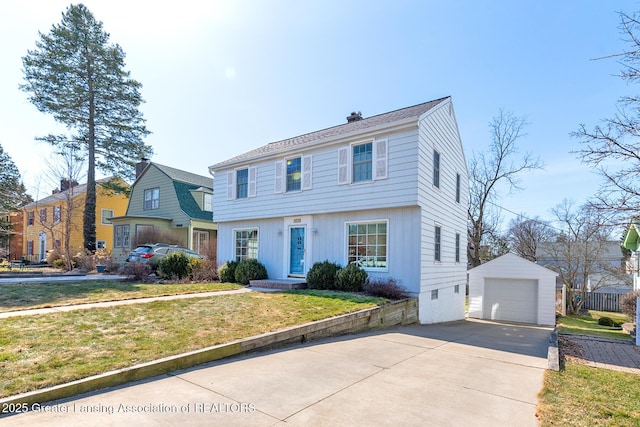 colonial home featuring a detached garage, a front lawn, an outdoor structure, and driveway