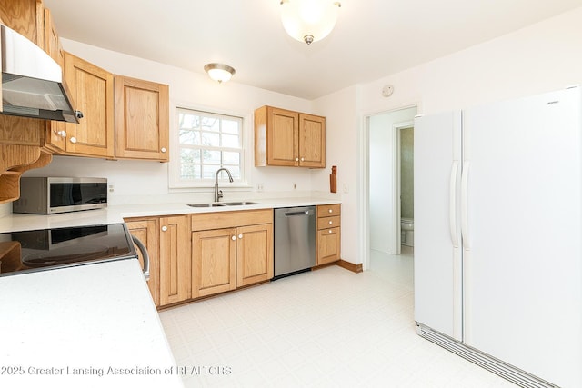 kitchen with light floors, light countertops, appliances with stainless steel finishes, exhaust hood, and a sink