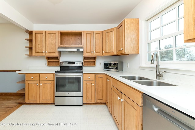 kitchen featuring open shelves, light countertops, exhaust hood, stainless steel appliances, and a sink