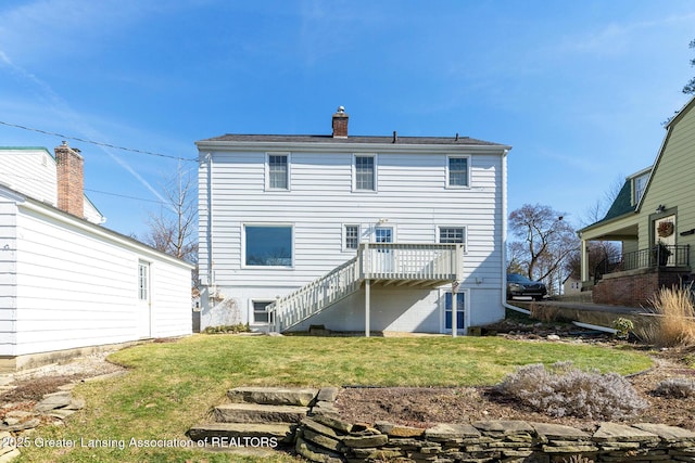 rear view of property with a deck, a chimney, stairs, and a yard