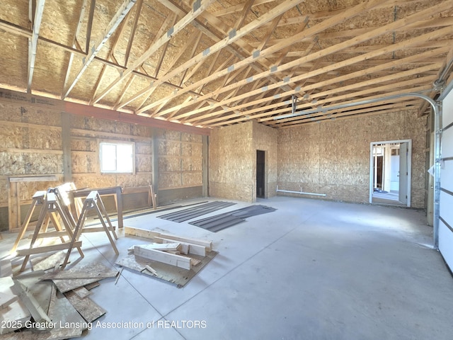 miscellaneous room with a garage and concrete floors