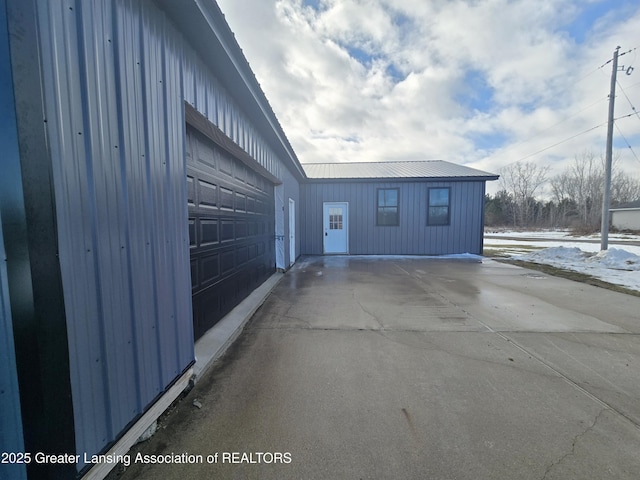 view of snowy exterior with a garage