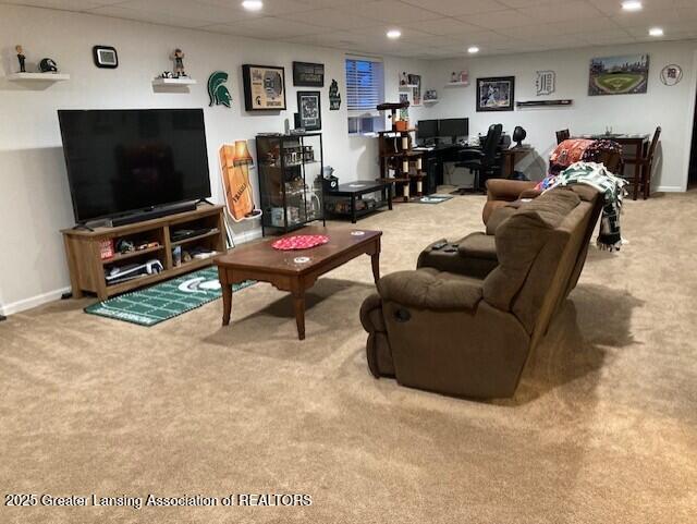 living room featuring light carpet, baseboards, a paneled ceiling, and recessed lighting