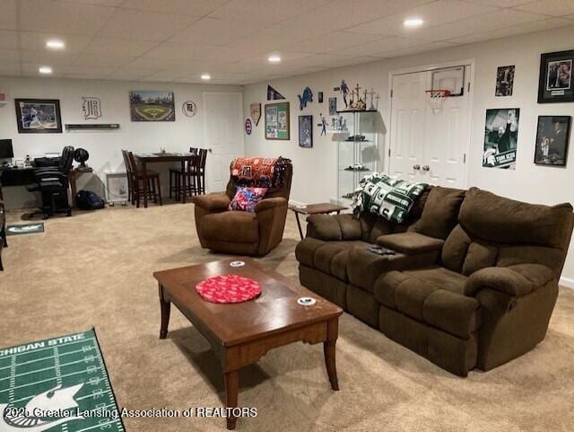 living area featuring recessed lighting, light carpet, and a drop ceiling