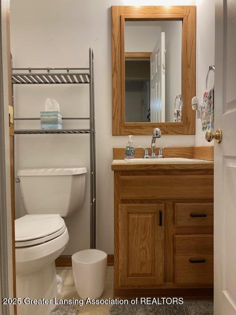 bathroom featuring toilet and vanity