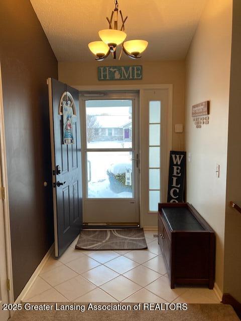 doorway featuring plenty of natural light and light tile patterned floors