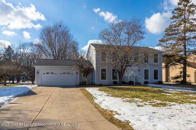 colonial house featuring an attached garage and concrete driveway