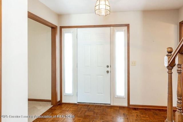 foyer featuring stairway and baseboards