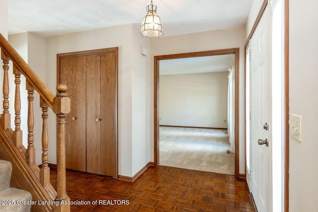 hallway with baseboards and stairway