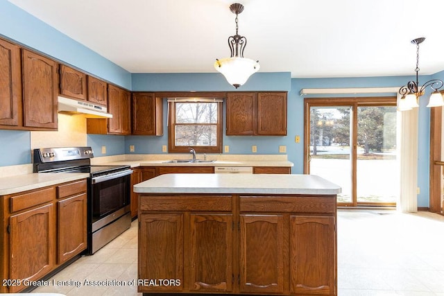 kitchen with light countertops, a sink, under cabinet range hood, and stainless steel electric range