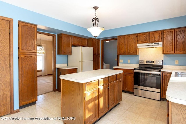 kitchen featuring a kitchen island, freestanding refrigerator, stainless steel electric stove, light countertops, and under cabinet range hood