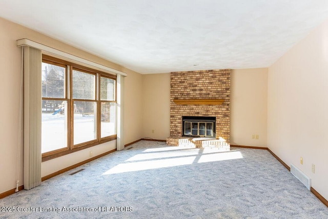 unfurnished living room with visible vents, a wealth of natural light, and carpet flooring