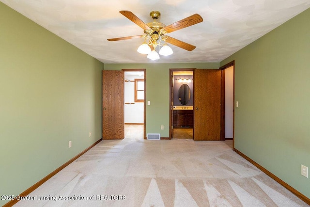 unfurnished bedroom with carpet floors, visible vents, and baseboards